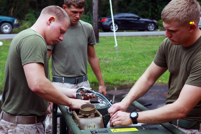 Marines with 2nd Marine Logistics Group put together the new joint service transportable decontamination system, or M26, during a training exercise aboard Camp Lejeune, N.C., Oct. 3, 2012. Servicemembers were graded by chemical, biological, radiological, nuclear defense specialists during a practical application portion of the class in order to receive certification on using the M26.