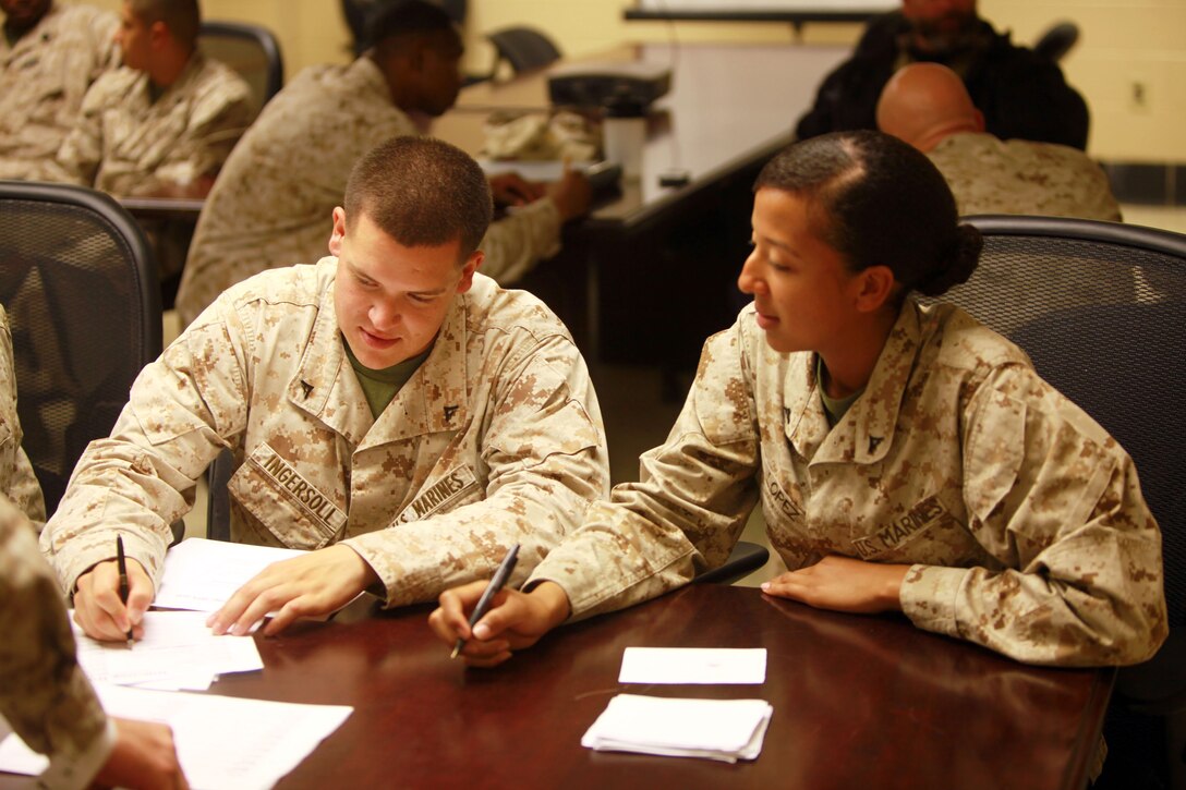 Marines with Combat Logistics Battalion 26, Combat Logistics Regiment 27, 2nd Marine Logistics Group help each other during a training exercise aboard Camp Lejeune, N.C., Oct. 2, 2012. Troops learned to process refugees that might have lost homes through natural disasters or any other endemic that causes hunger and privation so they can offer assistance.