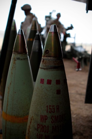 Marines serving with India Battery, 3rd Battalion, 11th Marine Regiment, line up artillery rounds in preparation to fire them during a regimental exercise here, Sept. 13, 2012. The exercise aimed to develop and sustain 11th Marine Regimentâ€™s ability to plan and execute artillery fires. Specifically, the artillery battalions trained in all aspects in fire support coordination, maneuvering, counter firing and supporting regimental command and control.