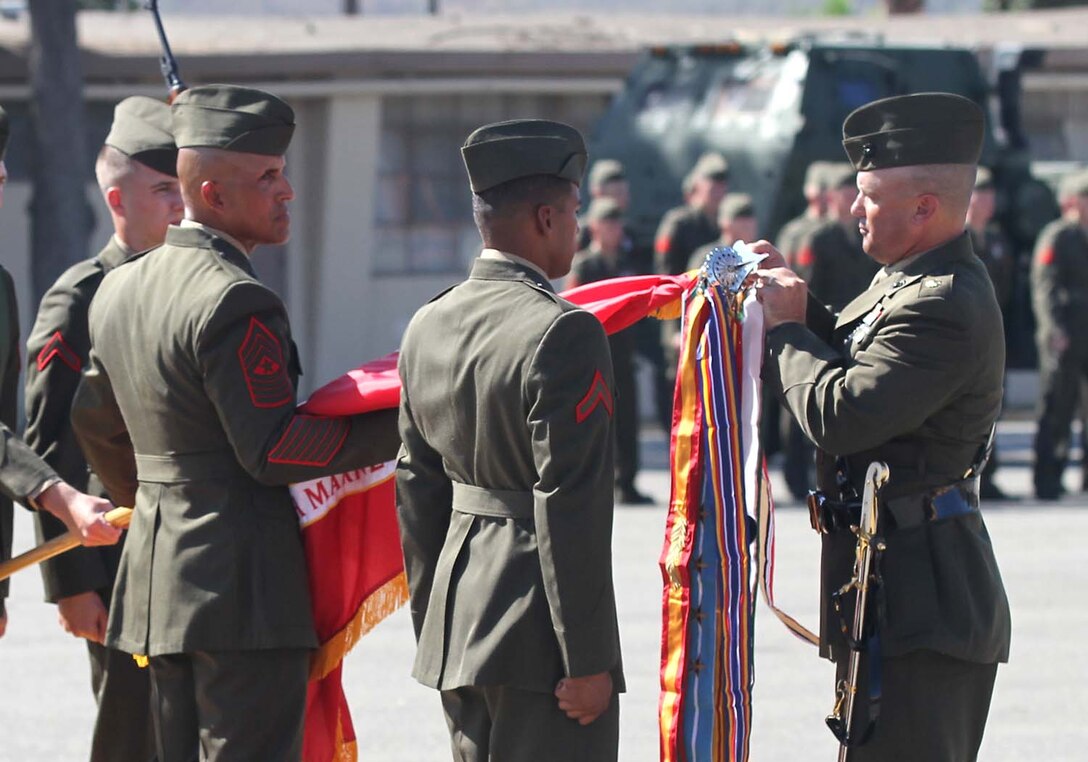 Major Timothy M. Flynn, the battalion executive officer of 5th Battalion, 11th Marine Regiment, attaches a battle streamer to the battalionâ€™s battle colors, during a rededication ceremony here, Oct. 3, 2012. The ceremony was held to honor the history of 5th Bn., 11th Marines, campaigns, battles and expeditions, which span from the battalionâ€™s activation at New River, N.C., in May 1942, to Operation Enduring Freedom in Afghanistan. The battalionâ€™s Quebec Battery was also reactivated during the ceremony, further reinforcing the Marine Corpsâ€™ expeditionary fighting force.