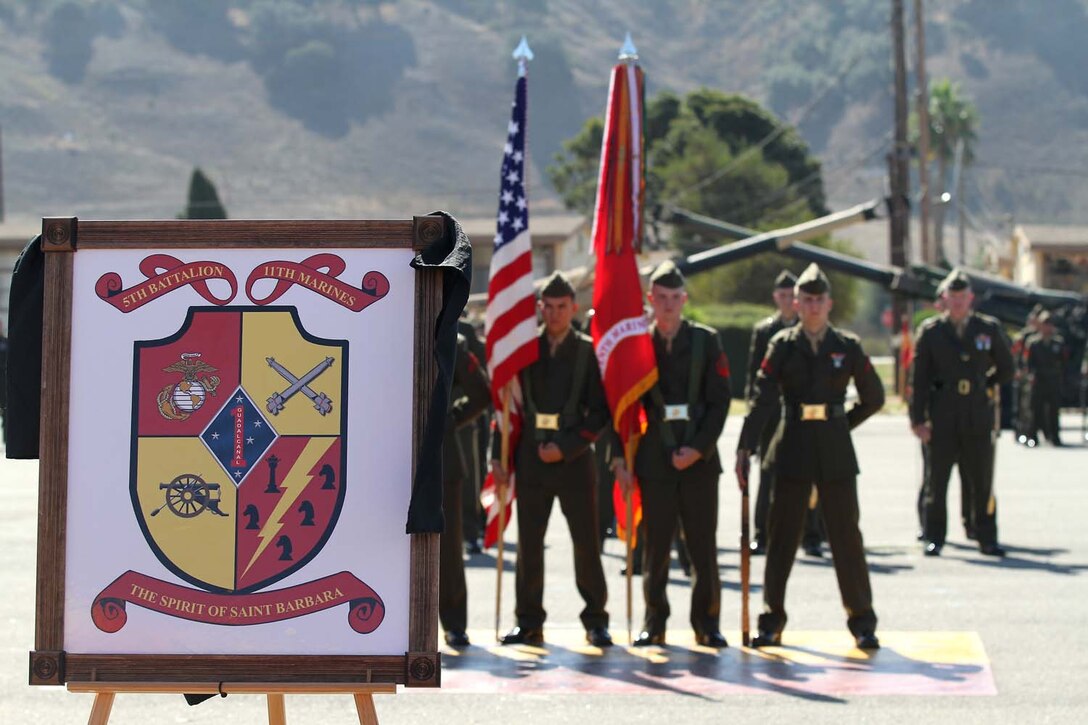 The 5th Battalion, 11th Marine Regiment color guard stands at parade rest behind the battalionâ€™s newly revealed insignia during a rededication ceremony here, Oct. 3, 2012. The ceremony was held to honor the history of 5th Bn., 11th Marines, campaigns, battles and expeditions, which span from the battalionâ€™s activation at New River, N.C., in May 1942, to Operation Enduring Freedom in Afghanistan. The battalionâ€™s Quebec Battery was also reactivated during the ceremony, further reinforcing the Marine Corpsâ€™ expeditionary fighting force.
