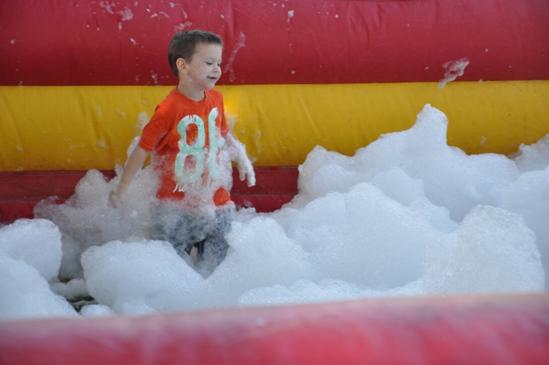 One of MCLB Barstow’s younger patrons enjoys a bubble bath inflatable bouncy-house during the Ohana Festival, Sept. 27. Various inflatables were set up during the festival to keep the younger guests busy. 