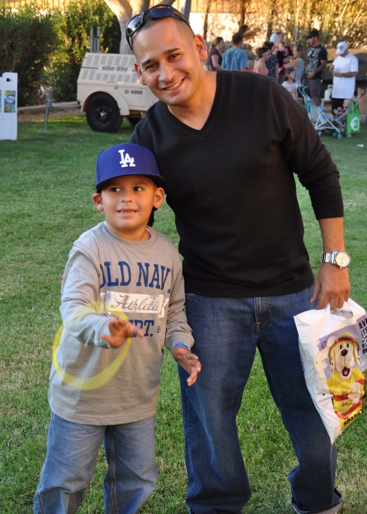Gunnery Sergeant Damon G. Garza, the provost sergeant aboard MCLB Barstow, spends quality time with his son, Devin Garza, during the Ohana Festival, Sept. 27.
