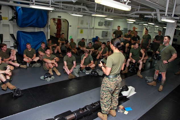 Corporal Elaine C. Romain, assessment consequence management team member, Chemical, Biological, Radiological and Nuclear Defense Platoon, 15th Marine Expeditionary Unit, gives a class to Weapons Company, Battalion Landing Team 3/5, 15th MEU, on some of the different tools CBRN Marines use to operate in contaminated environments, aboard the USS Peleliu, Oct. 4. The 15th MEU?s CBRN Defense Platoon is spending an entire month preparing the 2,400 servicemembers that make up the MEU on how to properly operate in contaminated environments. The 15th MEU is currently embarked as part of the Peleliu Amphibious Ready Group, while they serve as the nation's rapid-response sea-based Marine Air Ground Task Force for Western Pacific Deployment 12-02. Romain, 21, is from New Orleans.