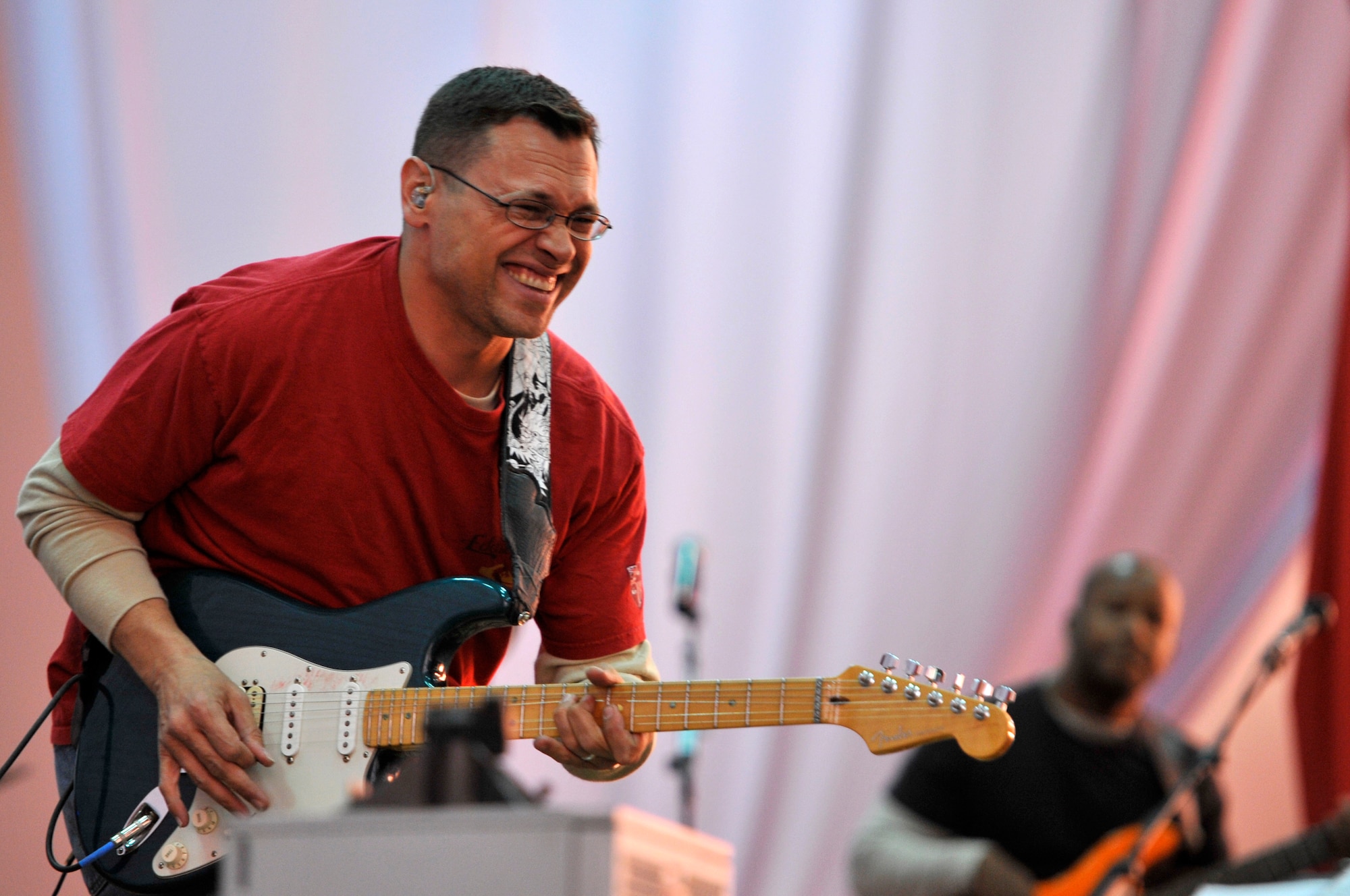 Staff Sgt. Gregory Lacy plays the guitar during a U.S. Air Forces Central band "Top Flight" performance Sept. 27, 2012 at the House of Youth, Naryn Province, Kyrgyzstan. Lacy who is the band's lead guitarist is deployed from Joint Base San Antonio, Texas and native of Houston. The band performed for more than 800 Kyrgyz residents while on a four-day U.S. Embassy led tour of Naryn. (U.S. Air Force photo/Master Sgt. Jason Vaught)