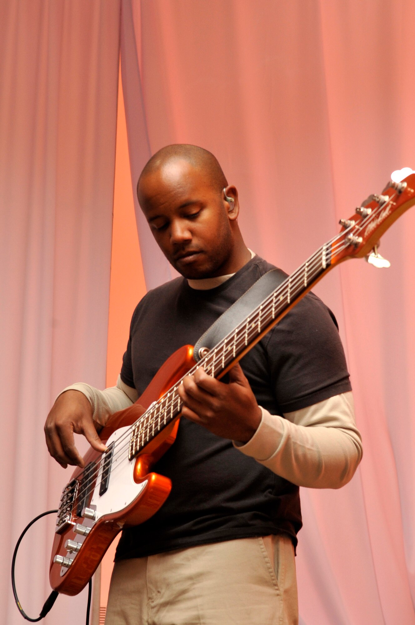 Senior Airman Henry Roberson warms up by making adjustments to his bass prior to a U.S. Air Forces Central band "Top Flight" performance Sept. 27, 2012 at the House of Youth, Naryn Province, Kyrgyzstan. Roberson who is Top Flight's bassist and male vocalist is stationed at Joint Base San Antonio and a native of Detroit. The band performed for more than 800 Kyrgyz residents while on a four-day U.S. Embassy led tour of Naryn. (U.S. Air Force photo/Master Sgt. Jason Vaught)