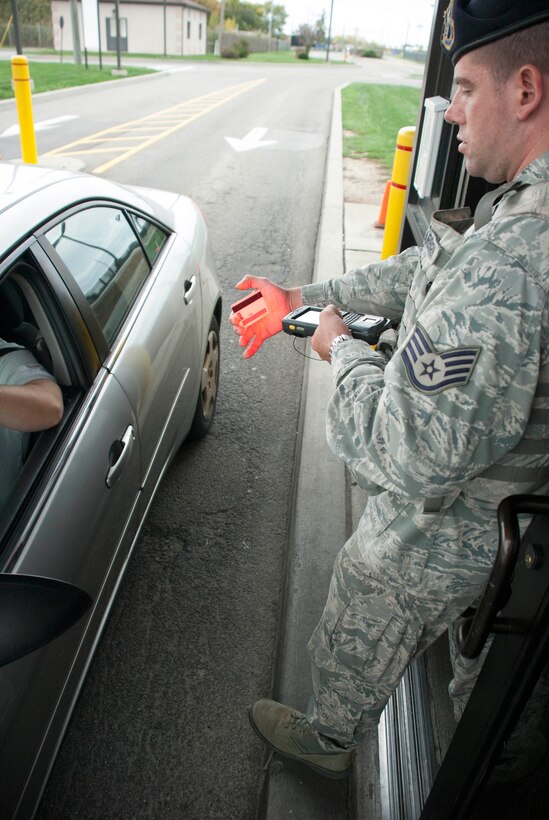 NIAGARA FALLS AIR RESERVE STATION N.Y. – 914th Security Forces Specialist Staff Sgt. Craig Dearborn scans an ID card with the Defense Biometric Identification System here at the base October 5.  DIBDS is a Department of Defense-mandated identity authentication tool and a control system which uses barcodes and biometrics to identify common access card holders at entry control points. (U.S. Air Force photo illustration by Staff Sgt. Andrew Caya)
