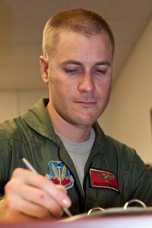 Capt. Jeffery Miller, 507th Air Defense Aggressor Squadron assistant director of operations, reviews a weapons school support binder Oct. 5, 2012, at Nellis Air Force Base Nev. Airmen of the 507th ADAS travel to foreign air shows to gather information on new Surface to air missile technology. (U.S. Air Force photo by Staff Sgt. Christopher Hubenthal)