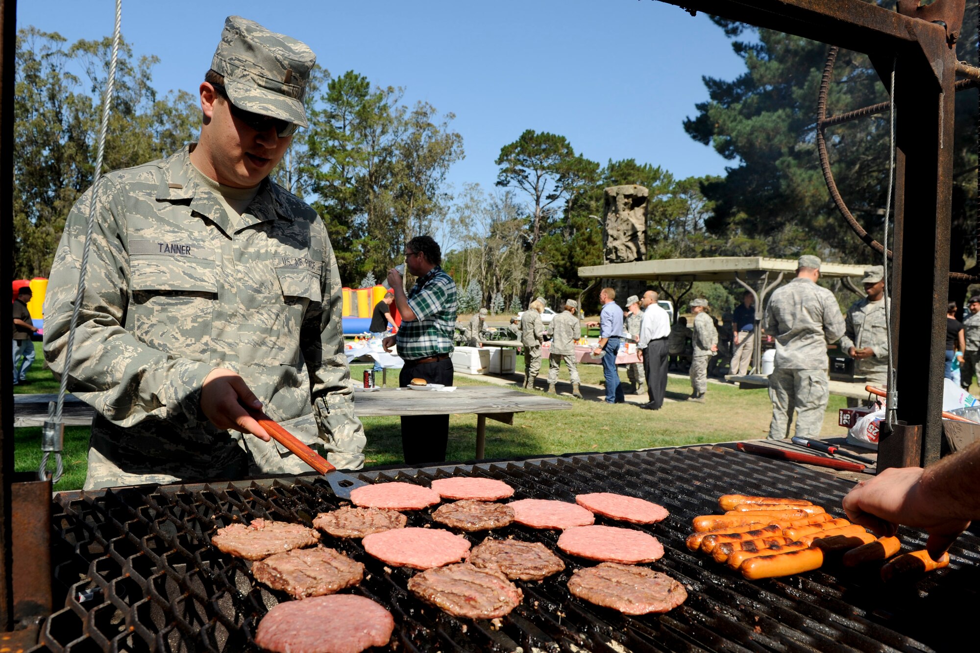 VANDENBERG AIR FORCE BASE, Calif. -- 2nd Lt. William Tanner, a 532nd Training Squadron member, flips burgers during the Combined Federal Campaign barbeque at Cocheo Park here Thursday, October, 4, 2012. The barbeque signaled the start of this year's CFC with organizational displays, a rock climbing wall and a human foosball court. The CFC runs until Nov. 12 at Vandenberg and is open to all military and civilian DOD employees. Interested contributors should contact their unit representative for more information or visit https://www.cfcnexus.org/_cfcgoldcoast to donate online until Dec. 15. (U.S. Air Force photo/Staff Sgt. Levi Riendeau)