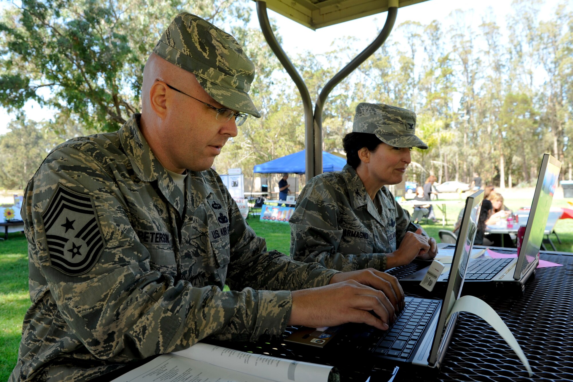 VANDENBERG AIR FORCE BASE, Calif. -- Chief Master Sgt. Ryan Peterson, 30th Space Wing command chief, donates to his favorite charity online during the Combined Federal Campaign Kickoff Barbecue at Cocheo Park here Thursday, Oct. 4, 2012. The barbeque signaled the start of this year's CFC with organizational displays, a rock climbing wall and a human foosball court. The CFC runs until Nov. 12 at Vandenberg and is open to all military and civilian DOD employees. Interested contributors should contact their unit representative for more information or visit https://www.cfcnexus.org/_cfcgoldcoast to donate online until Dec. 15. (U.S. Air Force photo/Staff Sgt. Levi Riendeau)

