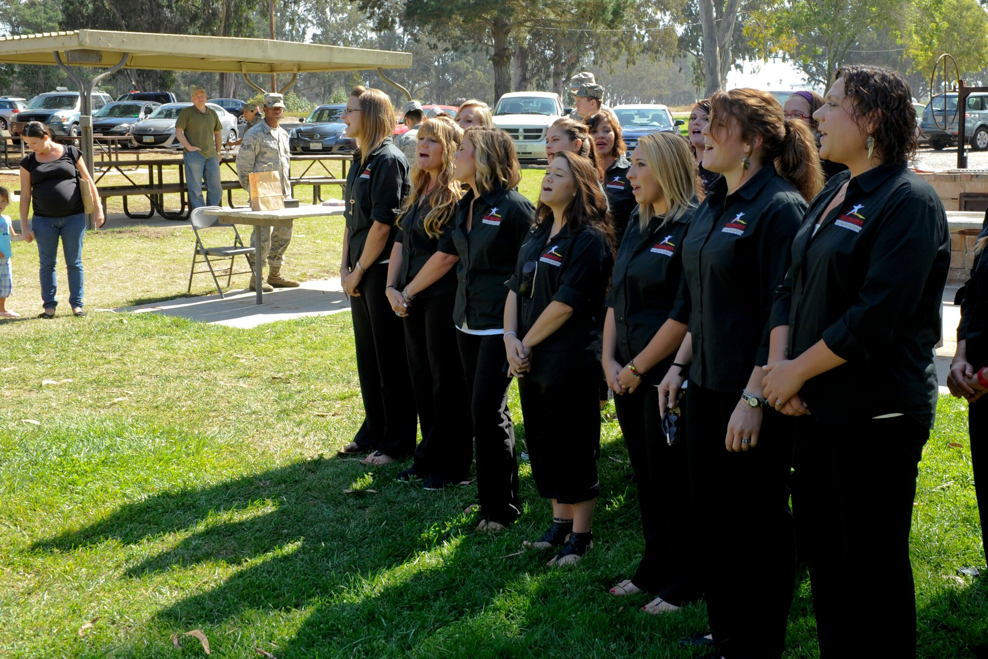 VANDENBERG AIR FORCE BASE, Calif. -- A choir from Teen Challenge sings a song during the Combined Federal Campaigns barbeque at Cocheo Park here Thursday, Oct., 4, 2012. The barbeque signaled the start of this year's CFC with organizational displays, a rock climbing wall and a human foosball court. The CFC runs until Nov. 12 at Vandenberg and is open to all military and civilian DOD employees. Interested contributors should contact their unit representative for more information or visit https://www.cfcnexus.org/_cfcgoldcoast to donate online until Dec. 15. (U.S. Air Force photo/Staff Sgt. Levi Riendeau)

