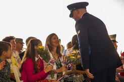 Tina Hartford receives a bouquet of flowers welcoming her to Joint Base Charleston – Air Base during the 437th Airlift Wing change of command ceremony Oct. 5, 2012, in Nose Dock 2 at JB Charleston - Air Base, S.C. Hartford is the wife of Col. Darren Hartford, the new 437th AW commander. (U.S. Air Force photo/Airman 1st Class George Goslin)