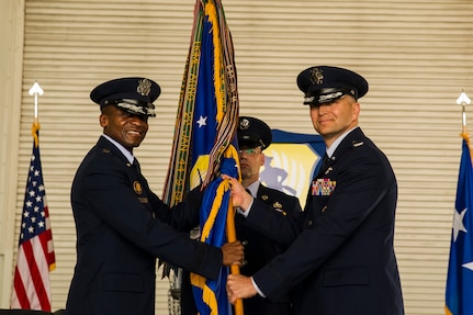 Col. Darren Hartford (right) accepts the 437th Airlift Wing guidon from Lt. Gen. Darren McDew, 18th Air Force commander, during the 437th AW change of command ceremony Oct. 5, 2012, in Nose Dock 2 here. Hartford took command from Col. Erik Hansen, whose next assignment is at Headquarters U.S. Africa Command in Stuttgart, Germany. (U.S. Air Force photo/Airman 1st Class George Goslin)