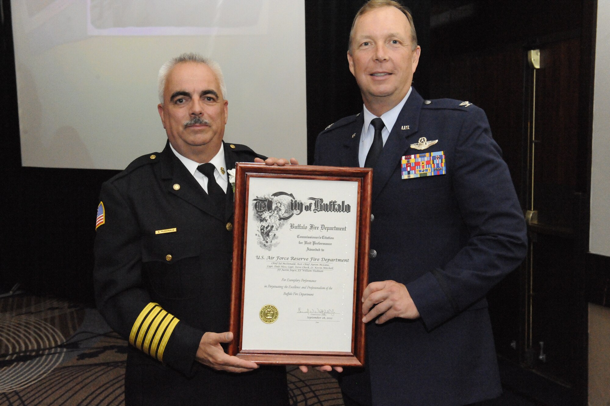 BUFFALO, N.Y. - Niagara Falls Air Reserve Station Fire Chief Edward McDonald (left) and 914th Airlift Wing Commander Al Swartzmiller hold the City of Buffalo Fire Commissioner’s Unit Citation. The Niagara Falls ARS Fire Department was awarded the citation for their actions in assisting civilian fire departments extinguish an industrial fire on Chandler St. in the city of Buffalo, N.Y. July 13, 2011.  (Courtesy photo)