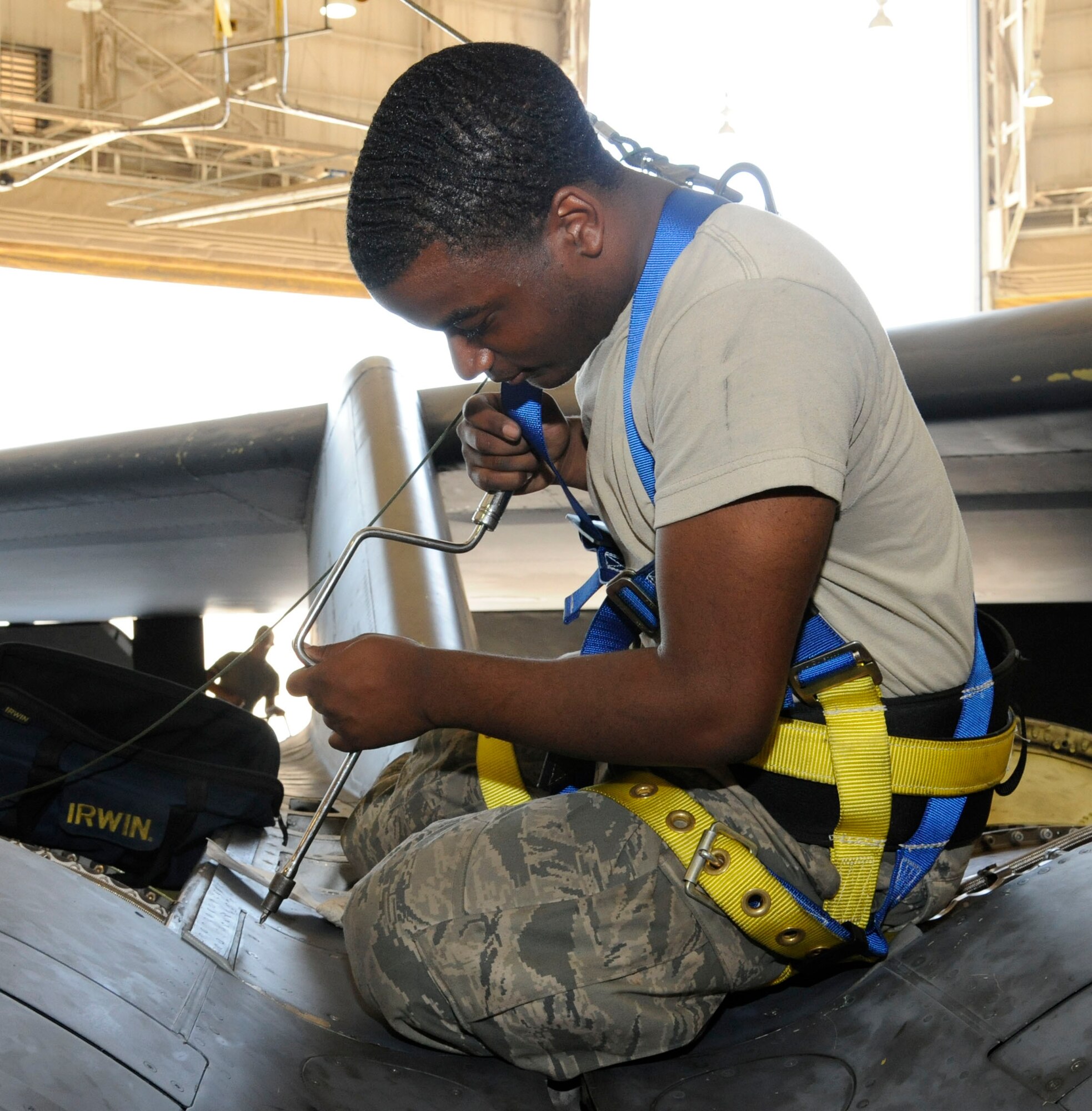 Airman 1st Class Mikel Stevens, 2nd Maintenance Squadron accessories flight electrical and environmental section, installs a valley panel on a B-52H Stratofortress on Barksdale Air Force Base, La., Oct. 4. Valley panels cover critical parts of the engine, this area contains the anti-icing units which prevent the engines from seizing up at high altitudes. Installation and repair to vital areas such as these are one of the areas of expertise E and E Airmen must obtain to ensure the Barksdale mission runs successfully. (U.S. Air Force photo/Airman 1st Class Andrew Moua)(RELEASED)