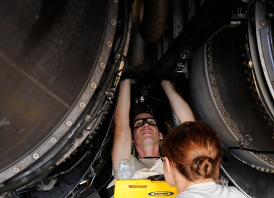 Airman 1st Class Johnathan Martin, 2nd Maintenance Squadron accessories flight electrical and environmental section, and Senior Airman Kaitlin Jarvis, 707th Maintenance Squadron accessories flight E and E section, conduct repairs on a B-52H Stratofortress on Barksdale Air Force Base, La., Oct. 4. The air duct they are replacing draws in air as the aircraft flies and uses the air to run the air conditioning, regulate cabin pressure and provide a source of air for aircrew. (U.S. Air Force photo/Airman 1st Class Andrew Moua)(RELEASED)