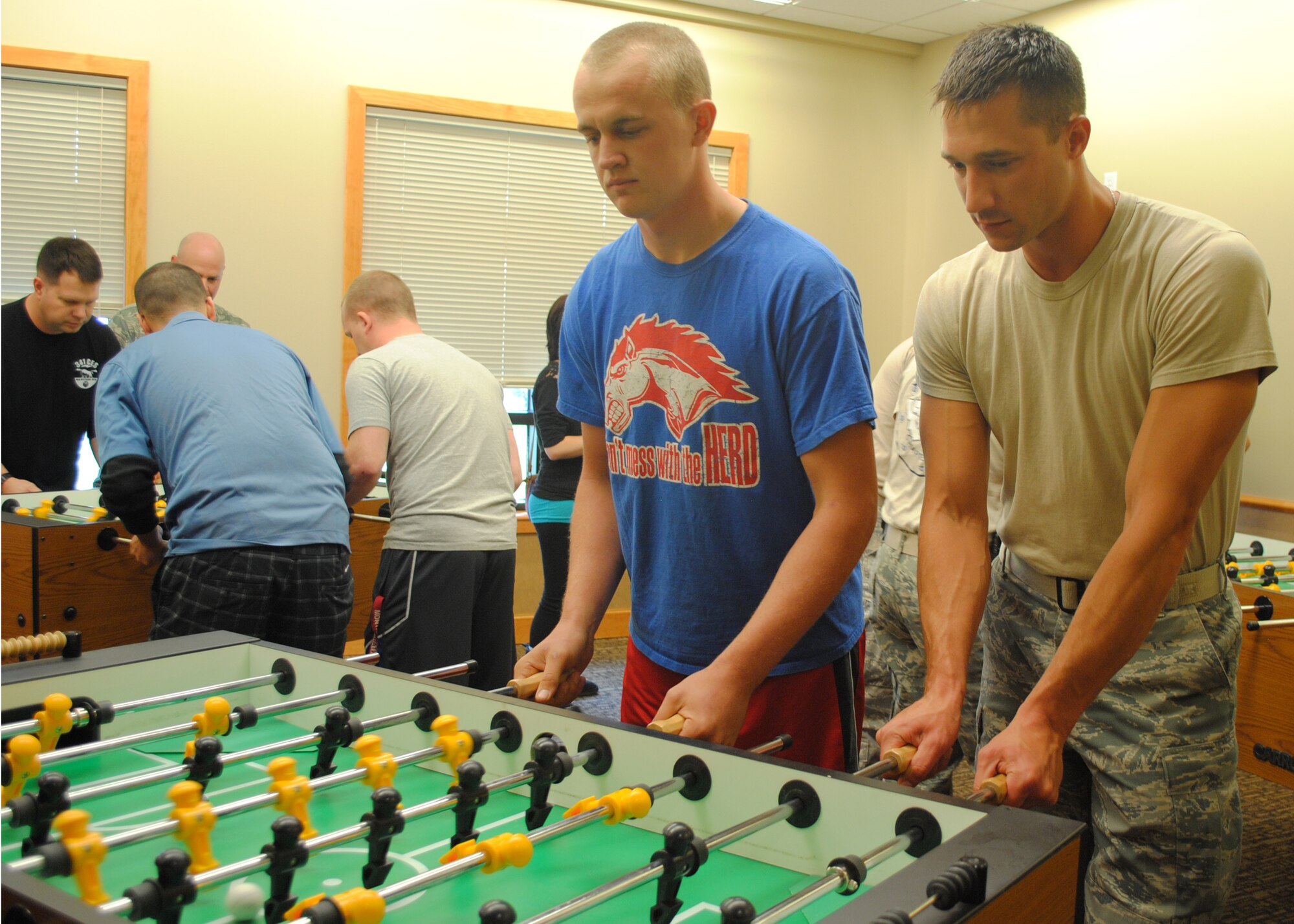 Senior Airman Christopher Goans, 819th RED HORSE Squadron member, left, and Staff Sgt. Douglas Maceiko, 819th RHS pavement and construction equipment operator, play a game of foosball during the Wing Sports Smackdown on Sept. 28 at the Grizzly Bend. Although they beat their components with a final score of 5 to 2, the eventual winners of the foosball tournament were Master Sgt. John Lynn, 341st Civil Engineer Squadron manager, and Master Sgt. Aldrin Saguin, 341st CES NCO in charge of missile grounds. (U.S. Air Force photo/Airman 1st Class Katrina Heikkinen)