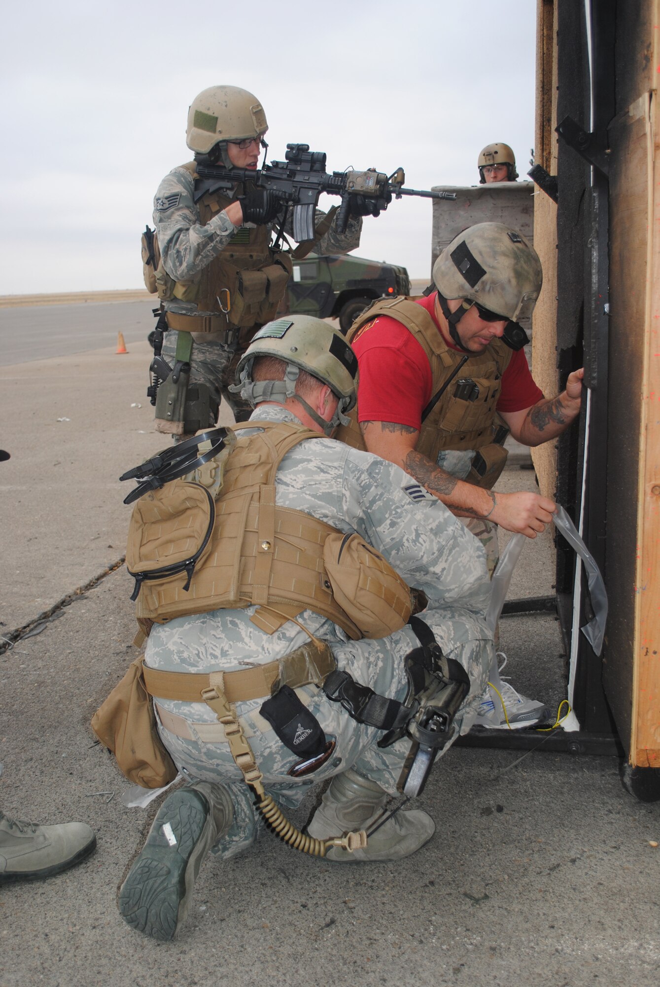 Senior Airman Jacob Twaddle, 341st SFG TRF member, helps Gilyeat enter the TRF shoot house facility as another TRF member watches behind them during a breeching scenario on Sept. 26. Complete with a vest and helmet, Gilyeat had a hands-on opportunity to practice breaching the facility and clearing the threat during his tour at Malmstrom. (U.S. Air Force photo/Airman 1st Class Katrina Heikkinen)