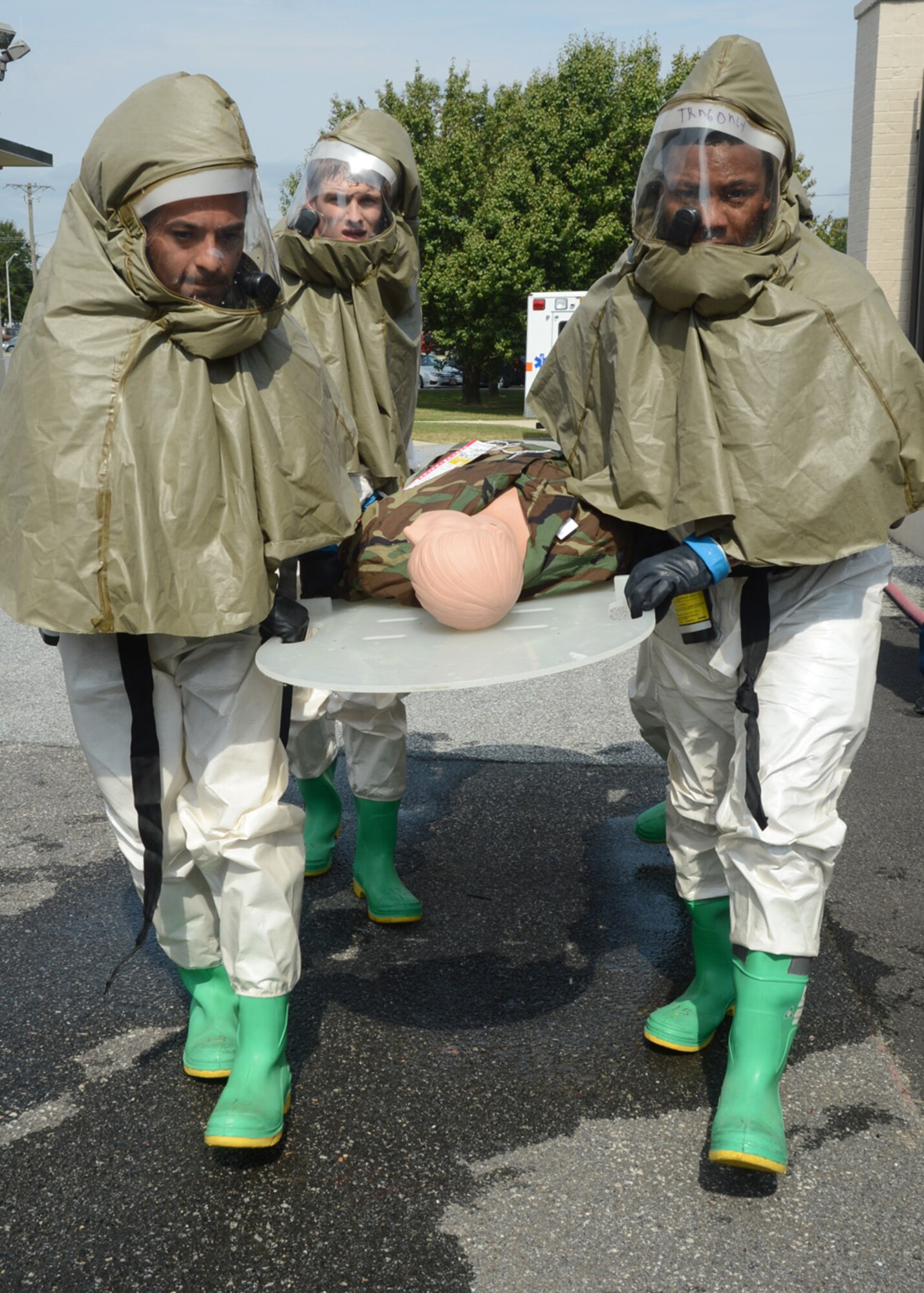 1st Lt. Juan Garcia, left, Staff Sgt. Bobby Davis, right, and Airman 1st Class Alexander Delfs, rear, carry a simulated patient to the patient decontamination tent Sept. 27, 2012, at the 436th Medical Group Clinic on Dover Air Force Base, Del. Members of the 436th MDG patient decontamination team received hands-on training on In-Place Patient Decontamination procedures. The IPPD is used at the medical treatment facility to decontaminate casualties and responders. (U.S. Air Force photo by Tech. Sgt. Chuck Walker)