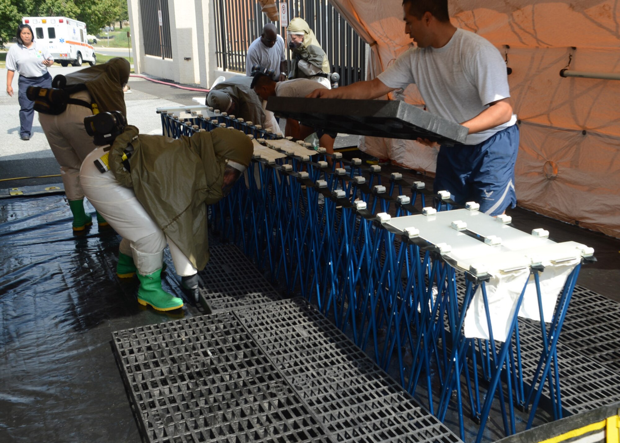Members of the 436th Medical Group assemble a patient decontamination tent Sept. 27, 2012, at the 436th MDG Clinic at Dover Air Force Base, Del. Members of the 436th MDG patient decontamination team received hands-on training on In-Place Patient Decontamination procedures. The IPPD is used at the medical treatment facility to decontaminate casualties and responders. (U.S. Air Force photo by Tech. Sgt. Chuck Walker)