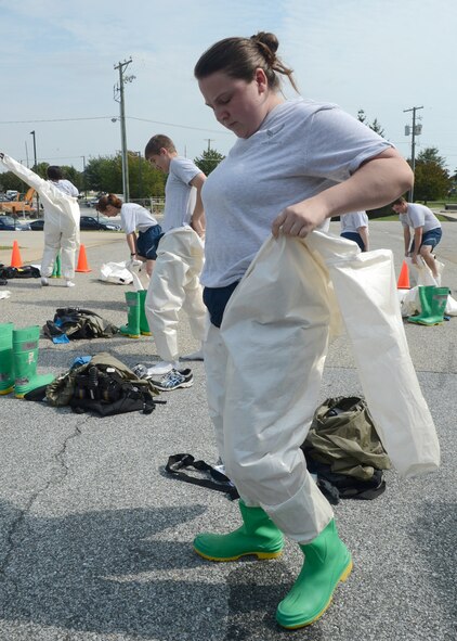 Senior Airman Laura Squires of the 436th Dental Squadron dons chemical protective gear Sept. 27, 2012, at the 436th Medical Group Clinic on Dover Air Force Base, Del. Squires was part of the 436th MDG patient decontamination team who received hands-on training on In-Place Patient Decontamination procedures. The IPPD is used at the medical treatment facility to decontaminate casualties and responders. (U.S. Air Force photo by Tech. Sgt. Chuck Walker)
