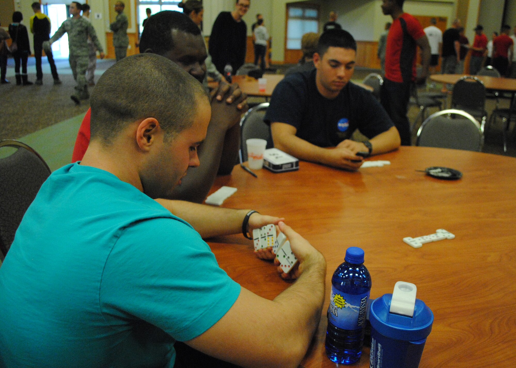 Airman 1st Class Adam Roberts, 341st Logistics Readiness Squadron traffic management apprentice, left, looks at his dominoes before making a move during a game at the Wing Sports Smackdown on Sept. 28. Airmen had the chance to choose from more than 10 games. From football and basketball, to Dance Central and ladder golf, there was something for everyone. (U.S. Air Force photo/Airman 1st Class Katrina Heikkinen)