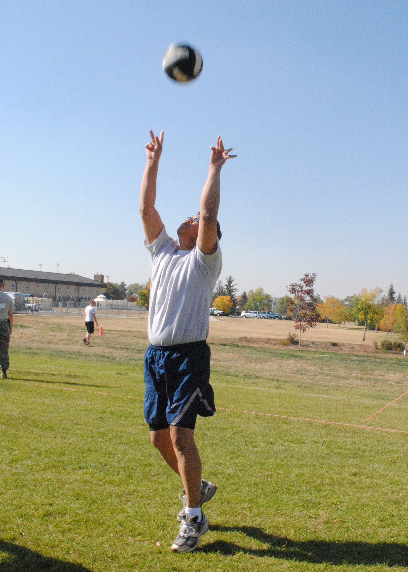 Col. H.B. Brual, 341st Missile Wing commander, sets a volleyball during a two-on-two game against 341st CES members.  Brual and his teammate, Master Sgt. Nicholas Sinnott, 341st Medical Operations Squadron bioenvironmental NCO in charge, beat the opposing team with a final score of 15 to 6 and were the eventual volleyball tournament winners. (U.S. Air Force photo/Airman 1st Class Katrina Heikkinen)