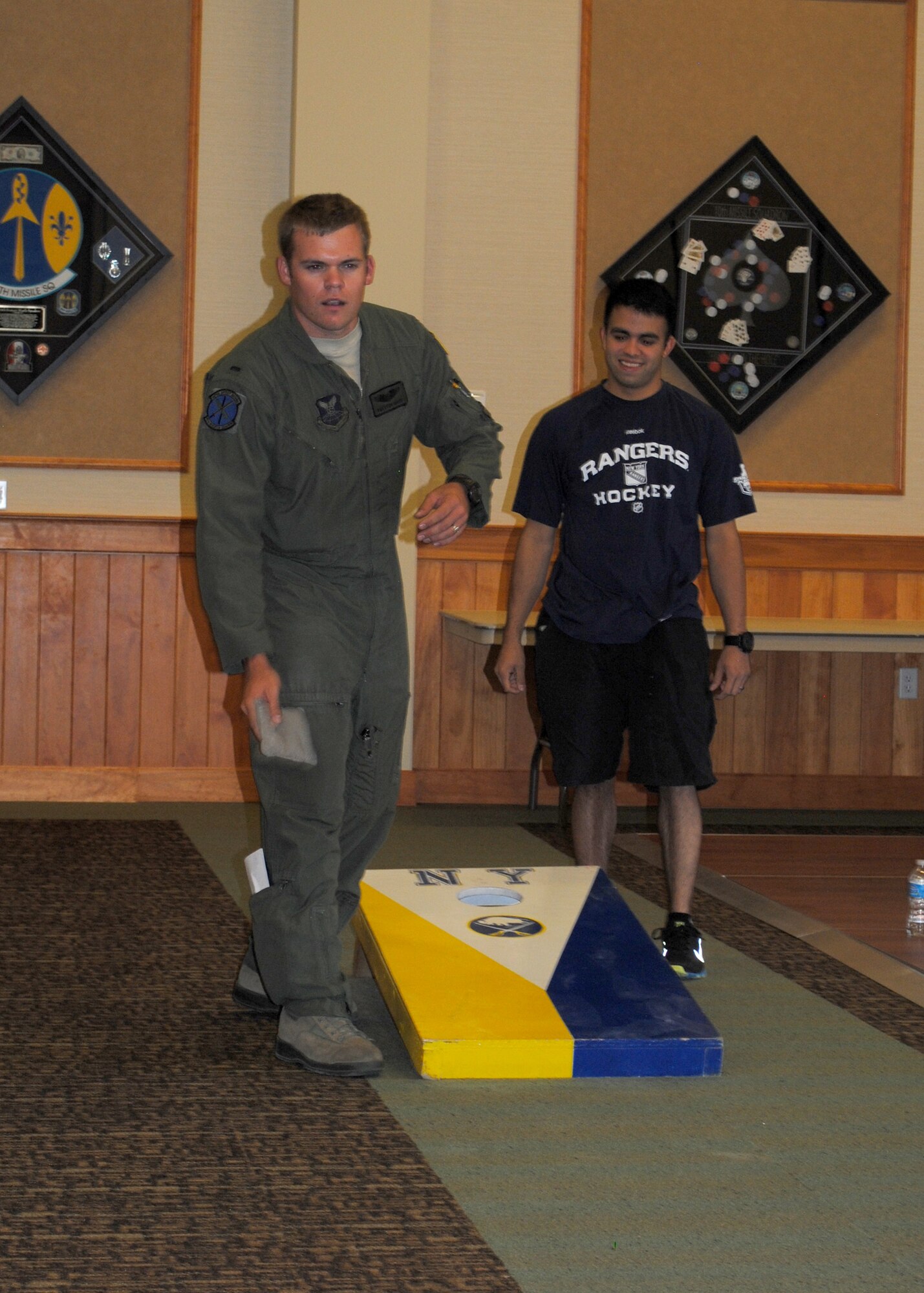 1st Lt. Preston Moon, 40th Helicopter Squadron standardization and evaluation liason officer and UH-1N helicopter pilot, throws a hackey sack as Airman 1st class Matthew Dubon, 341st Security Forces Group Tactical Response Force member, looks on. (U.S. Air Force photo/Airman 1st Class Katrina Heikkinen)
