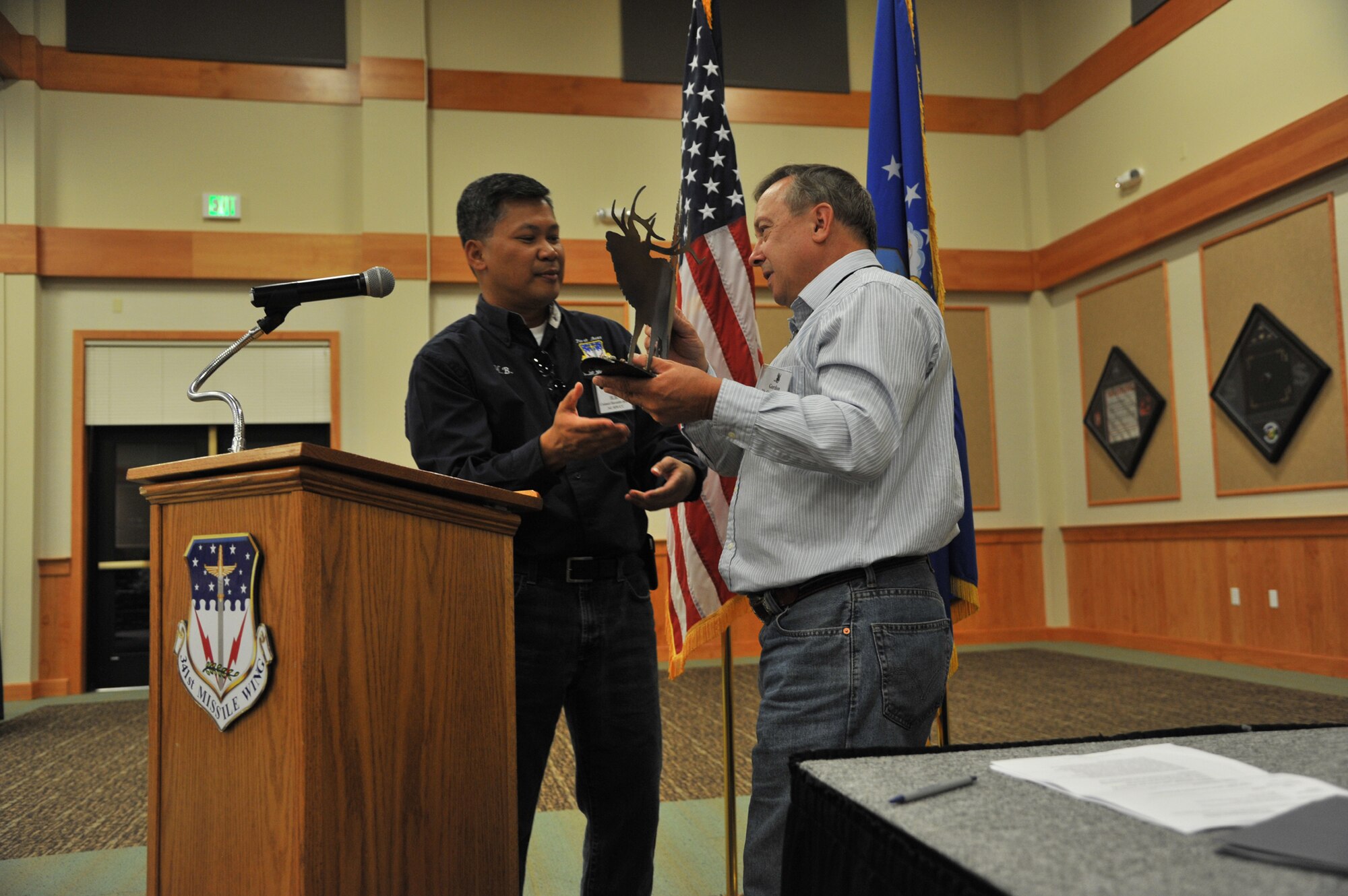 Col. H.B. Brual, 341st Missile Wing commander, left, presents Gordon Johnson, Military Affairs Committee chairman, with an appreciation gift for the MAC’s endless support of Wing One during a Salute to the Community dinner held at the Grizzly Bend on Sept. 29.   The dinner was held to express the appreciation members of Malmstrom Air Force Base have for the surrounding community.  (U.S. Air Force photo/John Turner)