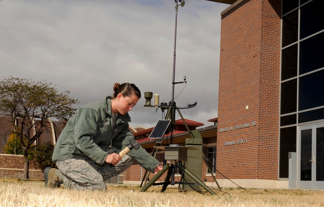 Senior Airman Nicole Blanton, 28th Operations Support Squadron weather forcaster, installs a lightning detector on the tactical meteorological observing system at Ellsworth Air Force Base, S.D., Oct. 4, 2012. The lightning detector can record lightning strikes within a 50 mile radius, allowing weather forcasters to provide accurate weather forecasts, which fosters the safety of base personnel. (U.S. Air Force photo by Airman 1st Class Anania Tekurio/Released)