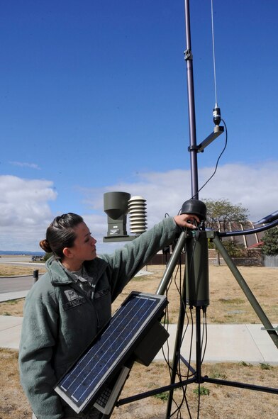 Senior Airman Nicole Blanton, 28th Operations Support Squadron weather forcaster, attaches a temperature humidity outlet onto a tactical meteorological observing system at Ellsworth Air Force Base, S.D., Oct. 4, 2012. The AN/TMQ - 53 system measures temperature and relative humidity conditions while in deployed locations. (U.S. Air Force photo by Airman 1st Class Anania Tekurio/Released)