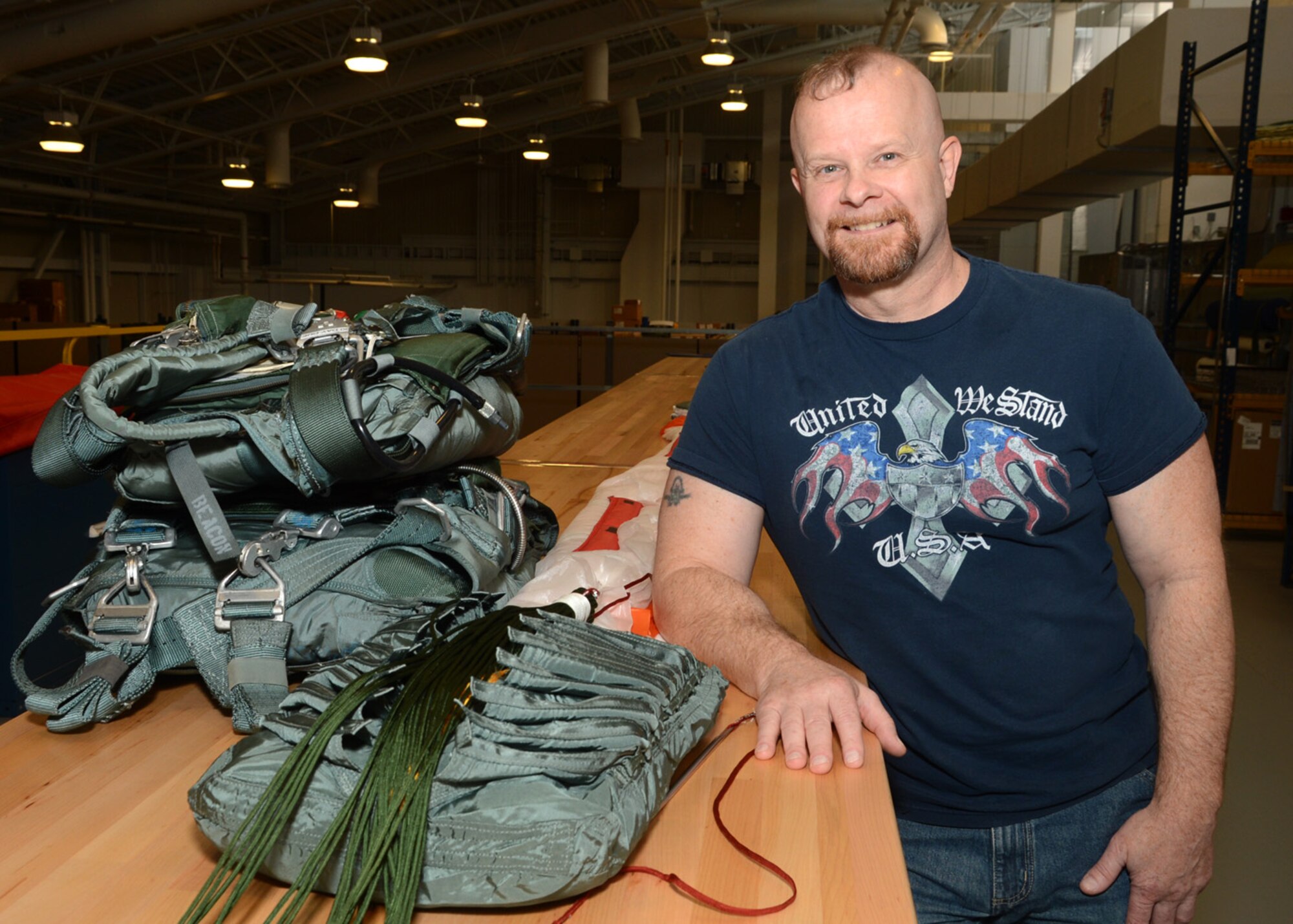 Dave Compton, 436th Operational Support Squadron Aircrew Flight Equipment technician, showcases packed parachutes inside the AFE building, Oct. 5, 2012, at Dover Air Force Base, Del. (U.S. Air Force photo by Tech. Sgt. Chuck Walker)