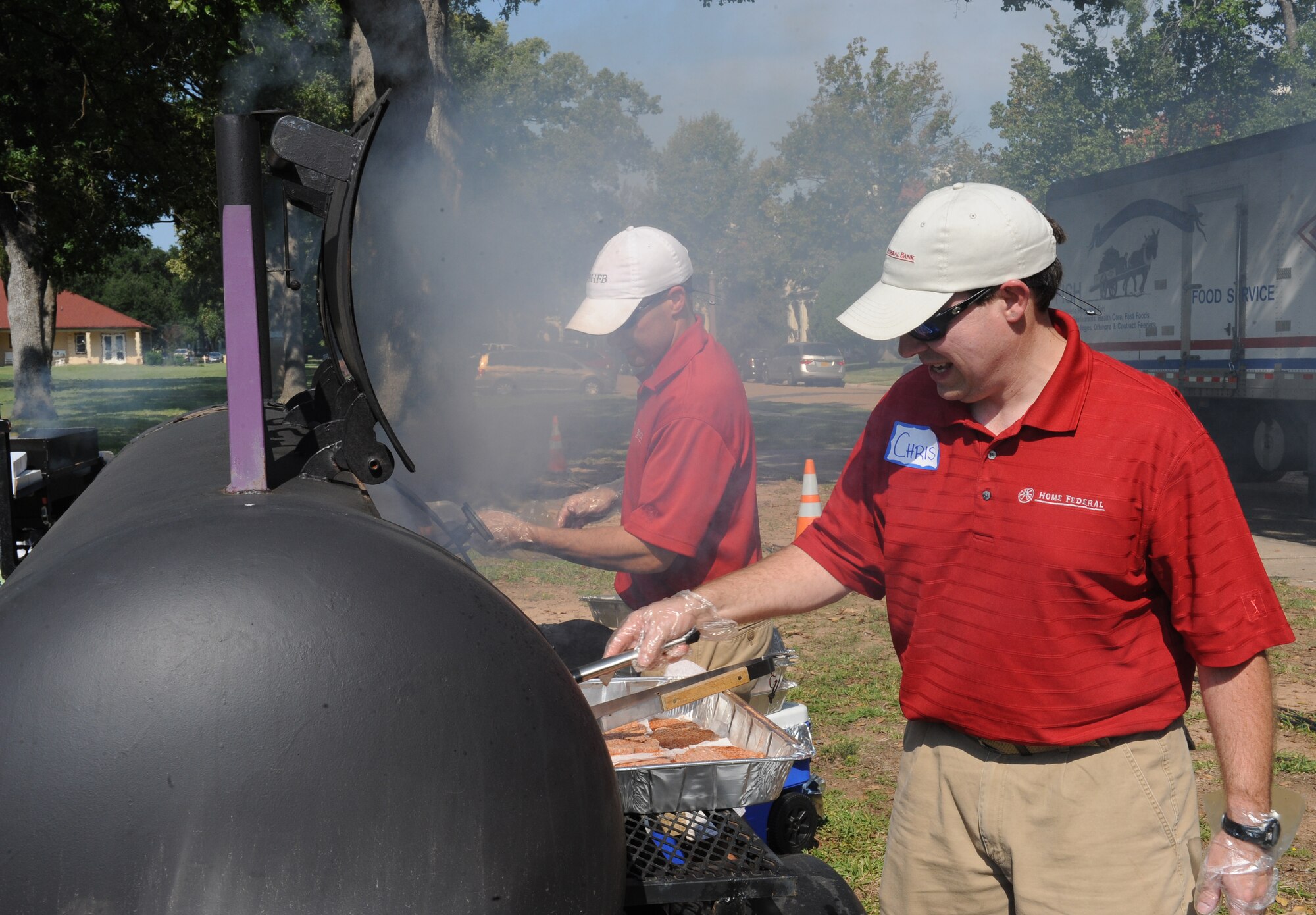 Members from a local business grill hamburgers and hot dogs during Celebrate Barksdale on Barksdale Air Force Base, La., Oct. 5. The 16th annual Celebrate Barksdale event was hosted by the Shreveport-Bossier Military Affairs Council and had volunteers from the local community. (U.S. Air Force photo/Airman 1st Class Benjamin Gonsier)(RELEASED) 

