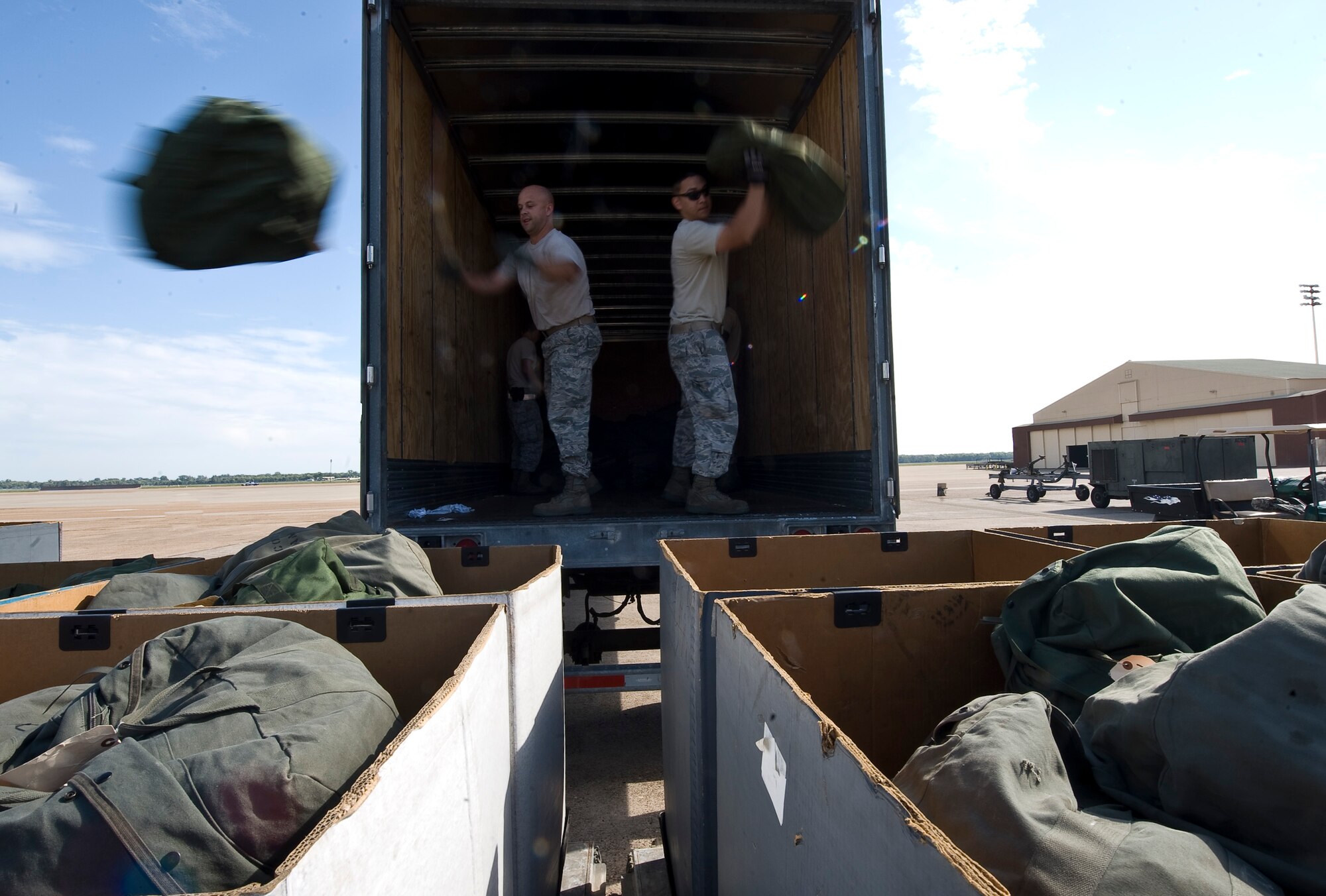 Airmen from the 2nd Logistics Readiness Squadron load chemical gear into containers to be shipped to Guam in support of a deployment from Barksdale Air Force Base, La., Oct. 2. The 96th Bomb Squadron left the previous day on a passenger aircraft, and any support equipment needed from Barksdale was shipped on a cargo plane separately. (U.S. Air Force photo/Staff Sgt. Chad Warren)(RELEASED)