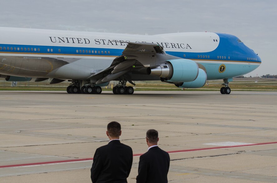 Secret Service agents watch as Air Force One departs Truax Field, Madison, Wisc., October 4, 2012. The President visted the base prior to speaking at Bascom Hill on the University of Wisconsin-Madison campus. (U.S. Air Force photo by Tech Sgt. Ashley Bell)