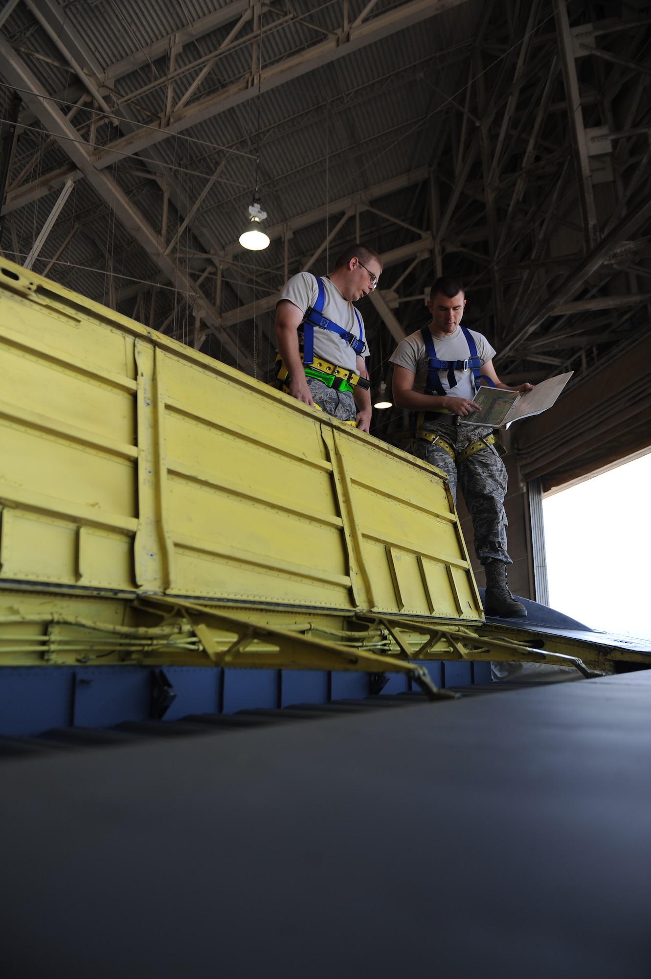Tech. Sgt. Robert Lefors and Staff Sgt. Michael Dickerson, 2nd Maintenance Group Quality Assurance Office, inspect a B-52H Stratofortress rudder on Barksdale Air Force Base, La., Oct. 2. Due to cracks found during a phase inspection, Airmen from the 2nd Maintenance Squadron removed and replaced the B-52s rudder. The B-52 provides the backbone of the bomber force with the ability for global attack and precision engagement. (U.S. Air Force photo/Senior Airman Micaiah Anthony)(RELEASED)
