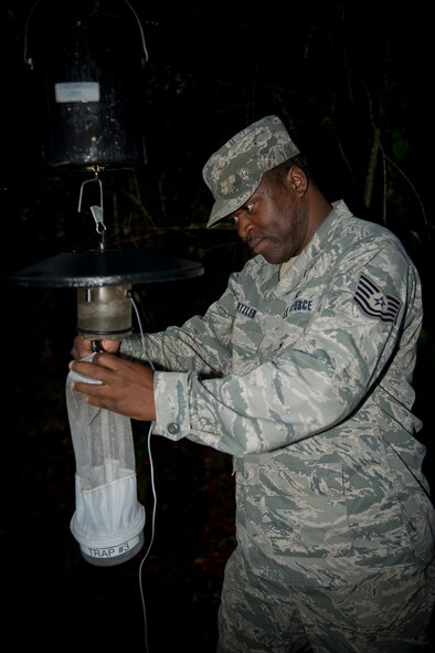 U.S. Air Force Tech. Sgt. Charles Dantzler, 23d Civil Engineer Squadron pest management NCO in charge, retrieves a net of mosquitoes at Moody Air Force Base, Ga., Oct. 3, 2012. After retrieving the net, the captured mosquitoes are sent to the 23d Medical Group public health flight for sorting and then sent to Wright-Patterson Air Force Base, Ohio, for analysis. (U.S. Air Force photo by Senior Airman Douglas Ellis/Released)
