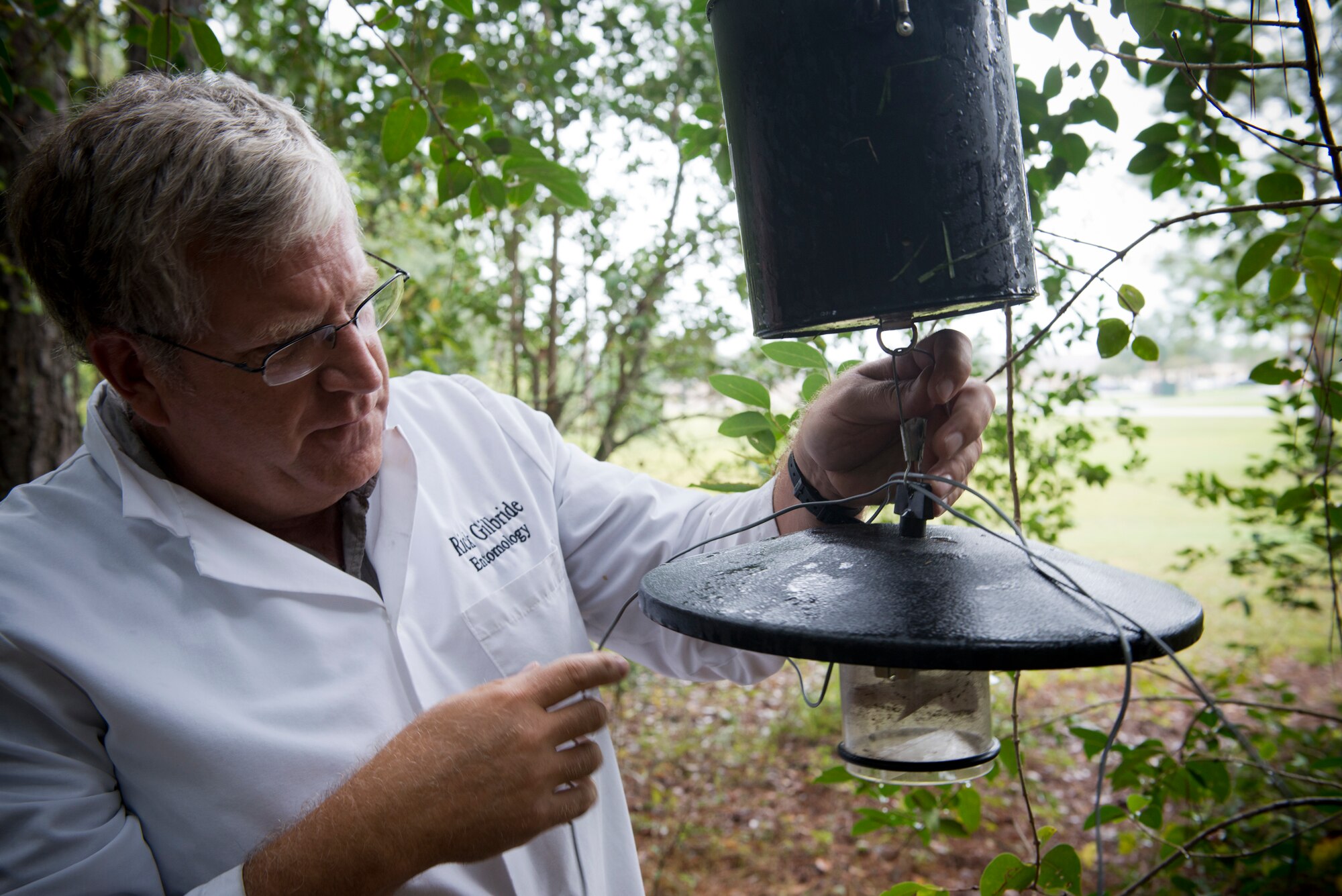 Rick Gilbridge, 23d Civil Engineer Squadron entomologist, sets a dry ice-infused mosquito trap at Moody Air Force Base, Ga., Oct. 3, 2012.  The mosquitoes are attracted to the carbon dioxide from the ice. The trap then uses a fan to suck the attracted mosquitoes into a net. (U.S. Air Force photo by Senior Airman Douglas Ellis/Released) 
