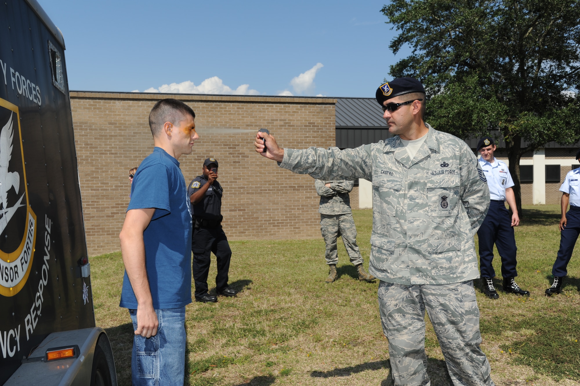 Staff Sgt. Jordan Nestor, 81st Security Forces Squadron, receives a spray of oleoresin capsaicin by Master Sgt. Erik Castro, 81st SFS, during OC spray training Sept. 3, 2012, at Keesler Air Force Base, Miss.  The training is a required one-time exposure of the OC spray for all Security Forces members.  (U.S. Air Force photo by Kemberly Groue)