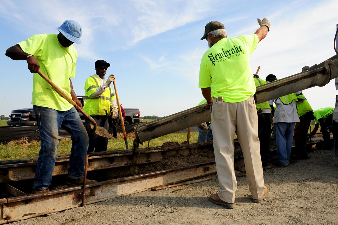 Civilian contractors build a side curb at Langley Air Force Base, Va., Oct. 5, 2012. The workers are constructing an extension of Lee Road due to traffic complications at the West Gate. (U.S. Air Force photo by Staff Sgt. Ashley Hawkins/Released)