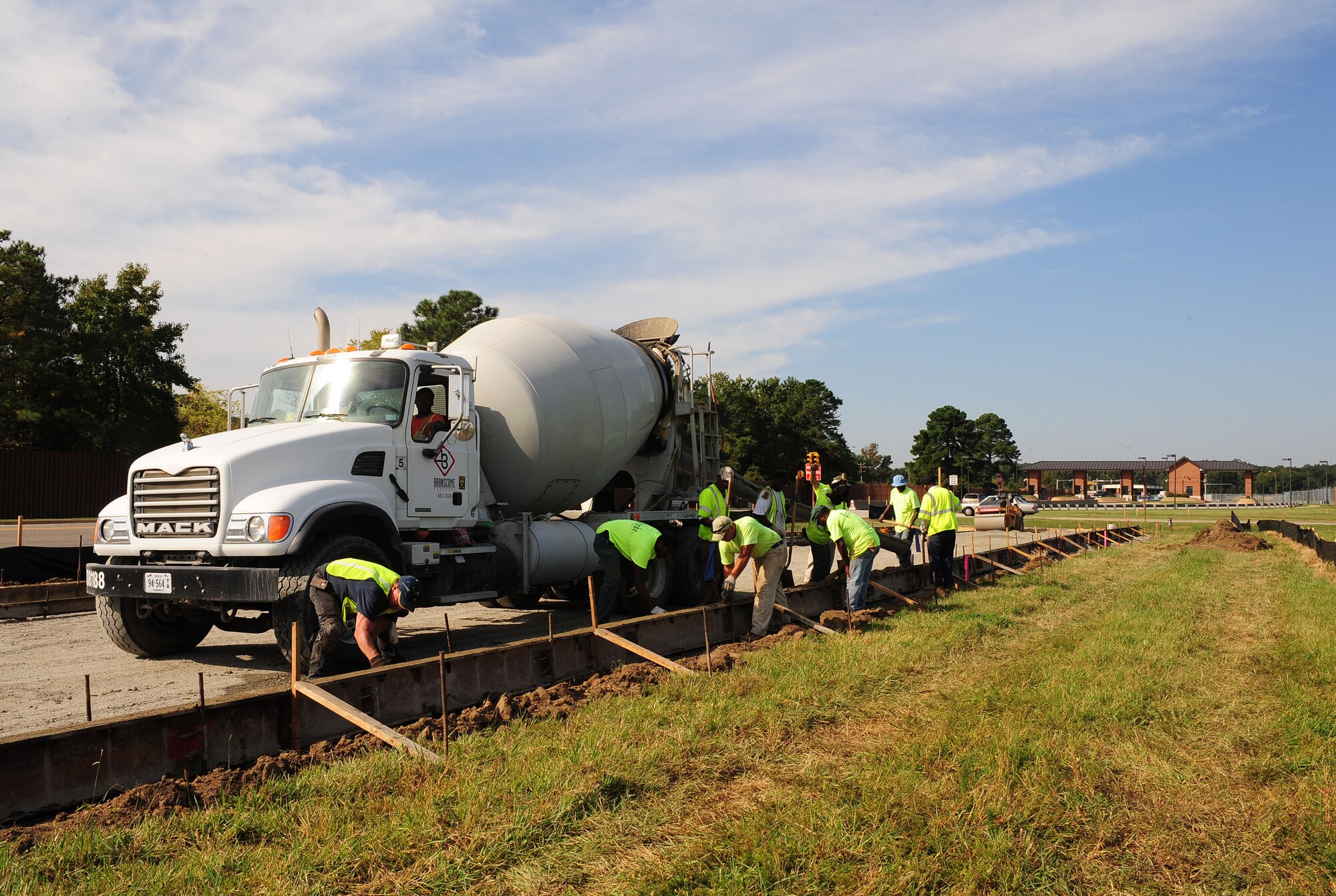 Civilian contractors level concrete for an extension of Lee Road near the West Gate at Langley Air Force Base, Va., Oct. 5, 2012. Due to traffic complications, the contractors are constructing a new road and traffic light. (U.S. Air Force photo by Staff Sgt. Ashley Hawkins/Released)