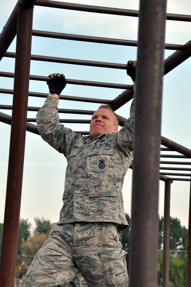 Staff Sgt. Andrew Vautrin, 90th Security Forces Squadron, focuses on moving across the monkey bars during the security forces obstacle course competition at Camp Guernsey, Wyo. for the Air Force Global Strike Command’s Global Strike Challenge Sept. 27. (U.S. Air Force photo by Senior Airman Dan Gage)
