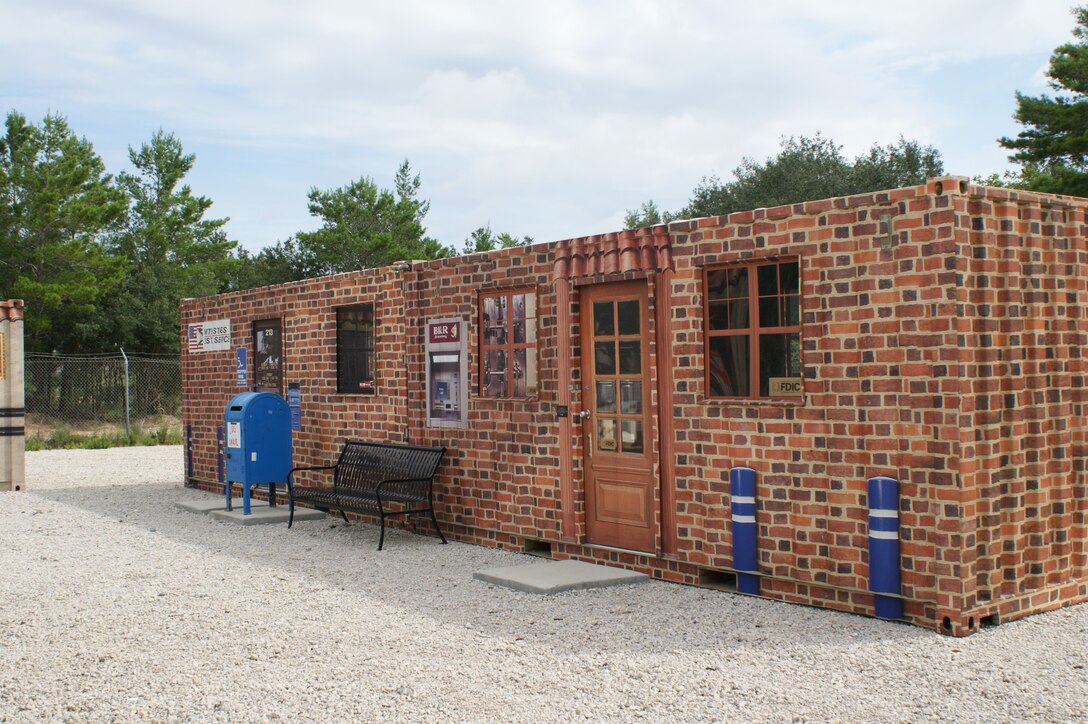A view of the post office and bank inside "CONUS Town", part of the Weapons of Mass Destruction Division training area at Naval School Explosive Ordnance Disposal at Eglin Air Force Base, Fla., July 20, 2012.  The town, used by students to practice searching for nuclear material, was one of multiple projects completed by the NAVSCOLEOD staff utilizing recyclable materials from the Defense Reutilization and Marketing Service. (U.S. Air Force photo/Dan Hawkins)