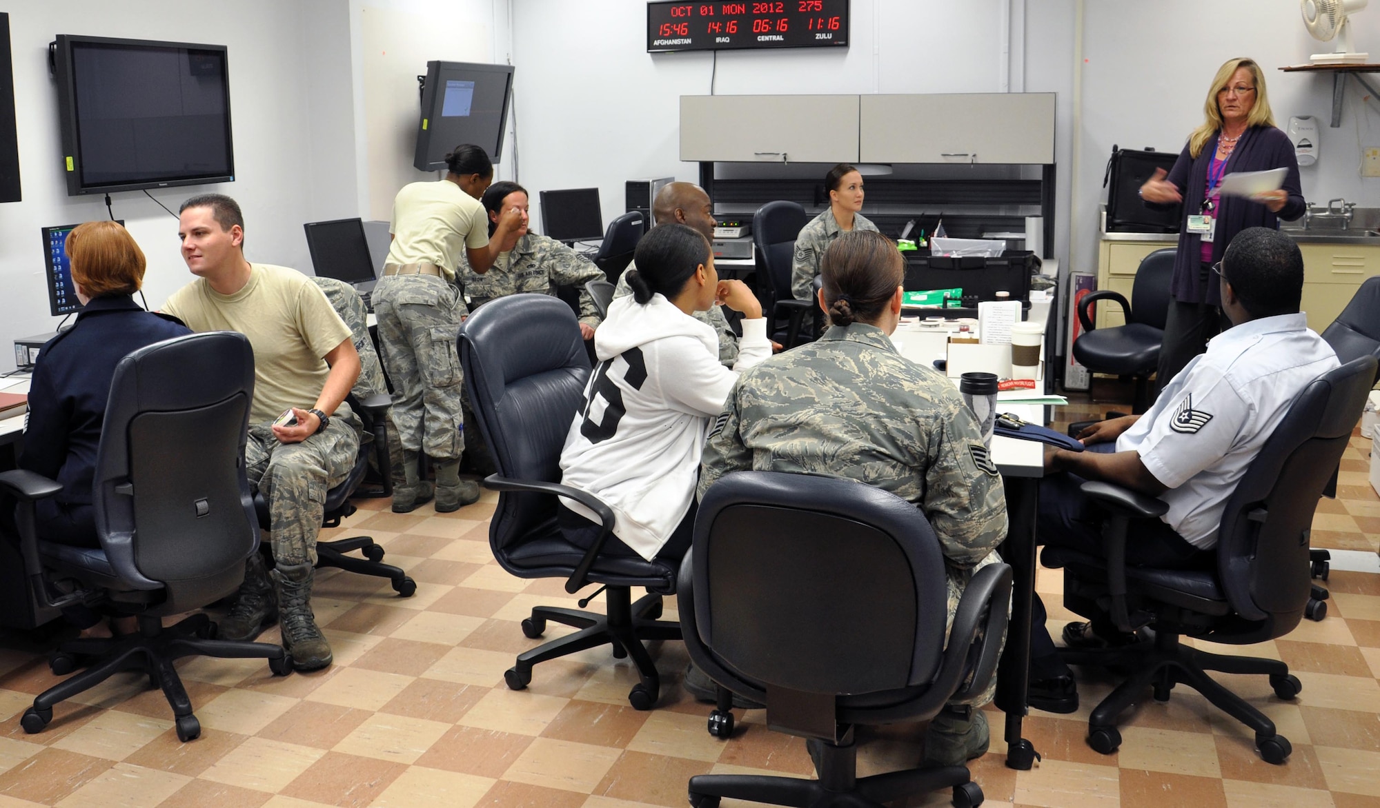 Family Advocacy Outreach Manager Sheri Ward gives instructions to volunteers from various squadrons across the base about how to best handle the Black-Eye Campaign experiment, while other volunteers receive black-eyes with makeup.  
The Black-Eye Campaign was initiaed by the Family Advocacy Office in hopes to raise awareness about domestic abuse during National Domestic Abuse Awareness Month.  (US Air Force Photo/ Josh Wilson)