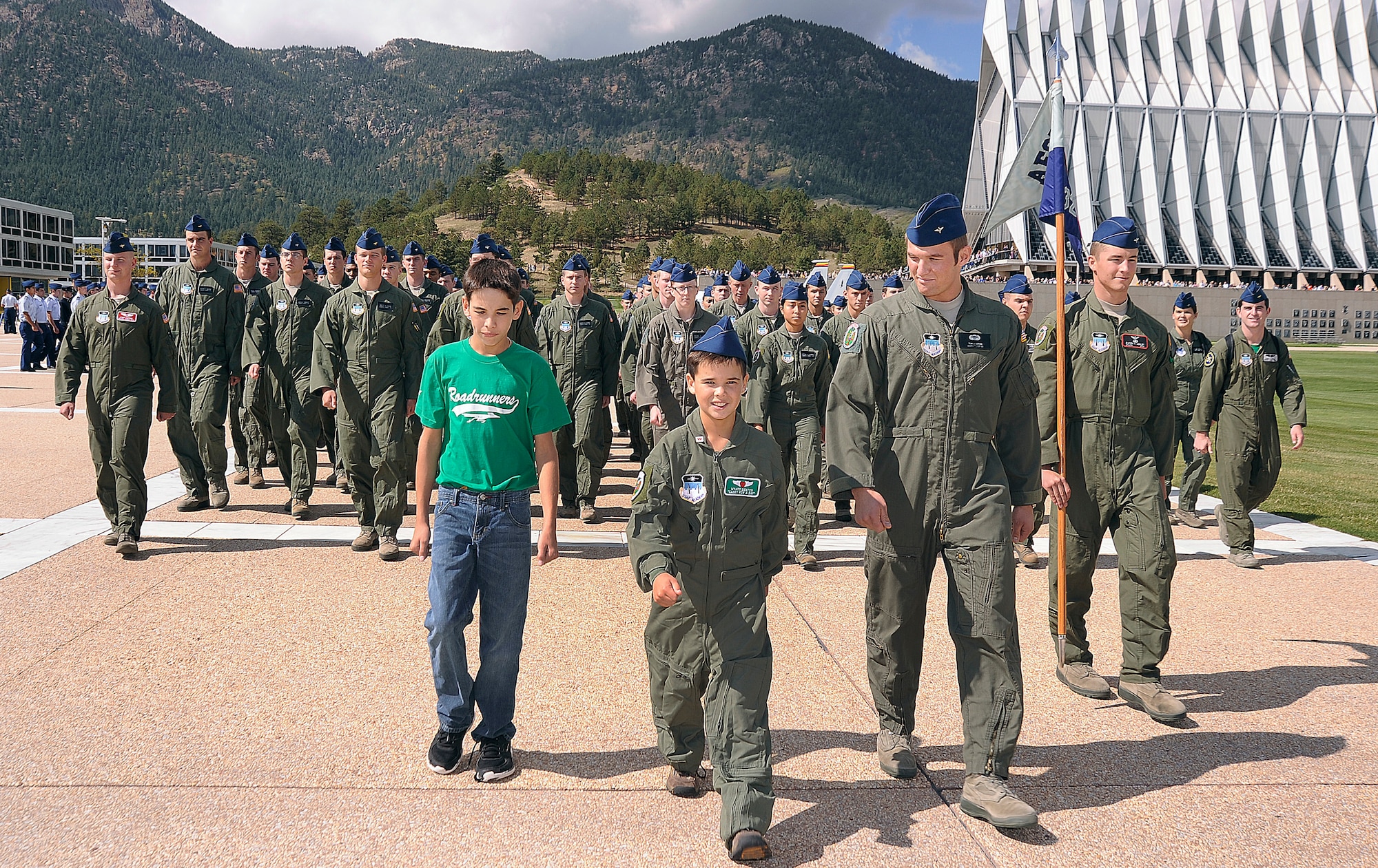 Wyatt Denton (center) and his brother Joe (left) march on the Terrazzo with Cadet Squardron 32 during Wyatt's Cadet for a Day experience Sept. 28, 2012. CS 32 was the sponsor squadron for Wyatt, a native of Parker, Colo. (U.S. Air Force photo/Sarah Chambers)