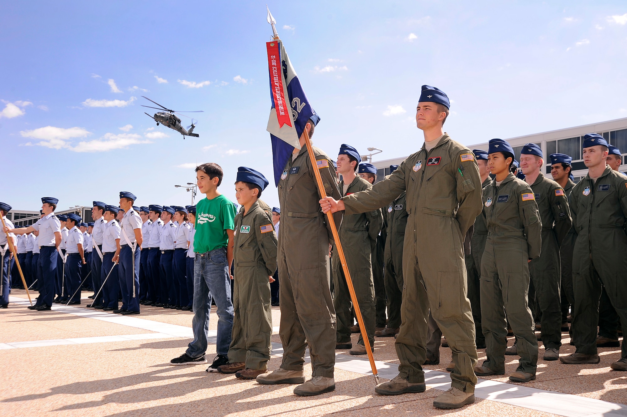 Joe and Wyatt Denton (center) stand at parade rest during a noon meal formation and HH-60 Pave Hawk flyover at the Air Force Academy Sept. 28, 2012. Wyatt was made a cadet for a day through the Academy's partnership with the Make-a-Wish Foundation. (U.S. Air Force photo/Sarah Chambers)