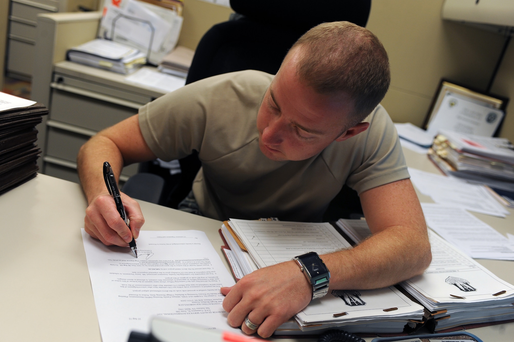 U.S. Air Force Staff Sgt. Aaron Caraway, 4th Contracting Squadron services team leader, signs a contract for tree and shrub renovation on Seymour Johnson Air Force Base, N.C., Oct. 3, 2012. During fiscal year 2012, the 4th CONS awarded more than $73 million in contracts, the most ever for Seymour Johnson. (U.S. Air Force photo/Airman 1st Class John Nieves Camacho/Released)