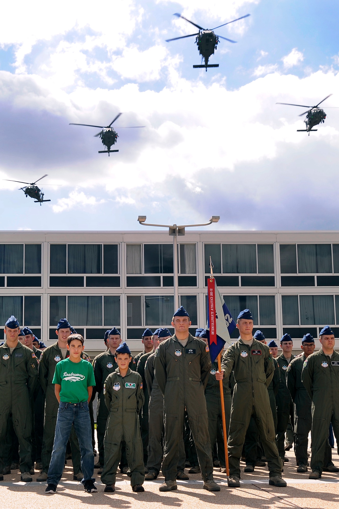 Wyatt Denton (center) and his brother Joe (left) stand on the Terrazzo with Cadet Squardron 32, Sept. 28. HH-60 Pave Hawk helicopters from the 34th Weapons Squadron at Nellis Air Force Base, Nev., flew over the noon meal formation. Wyatt is a native of Parker, Colo. (U.S. Air Force photo/Sarah Chambers)