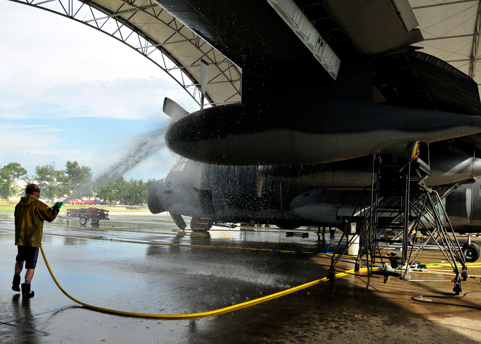 An aircraft maintenance contractor sprays down an MC-130E Combat Talon I at Duke Field's wash rack facility recently.  The 919th Special Operations Wing is half way through the process to retire its Talon inventory as it transitions to its new aviation foreign internal defense mission.  (U.S. Air Force photo/Tech. Sgt. Cheryl Foster)