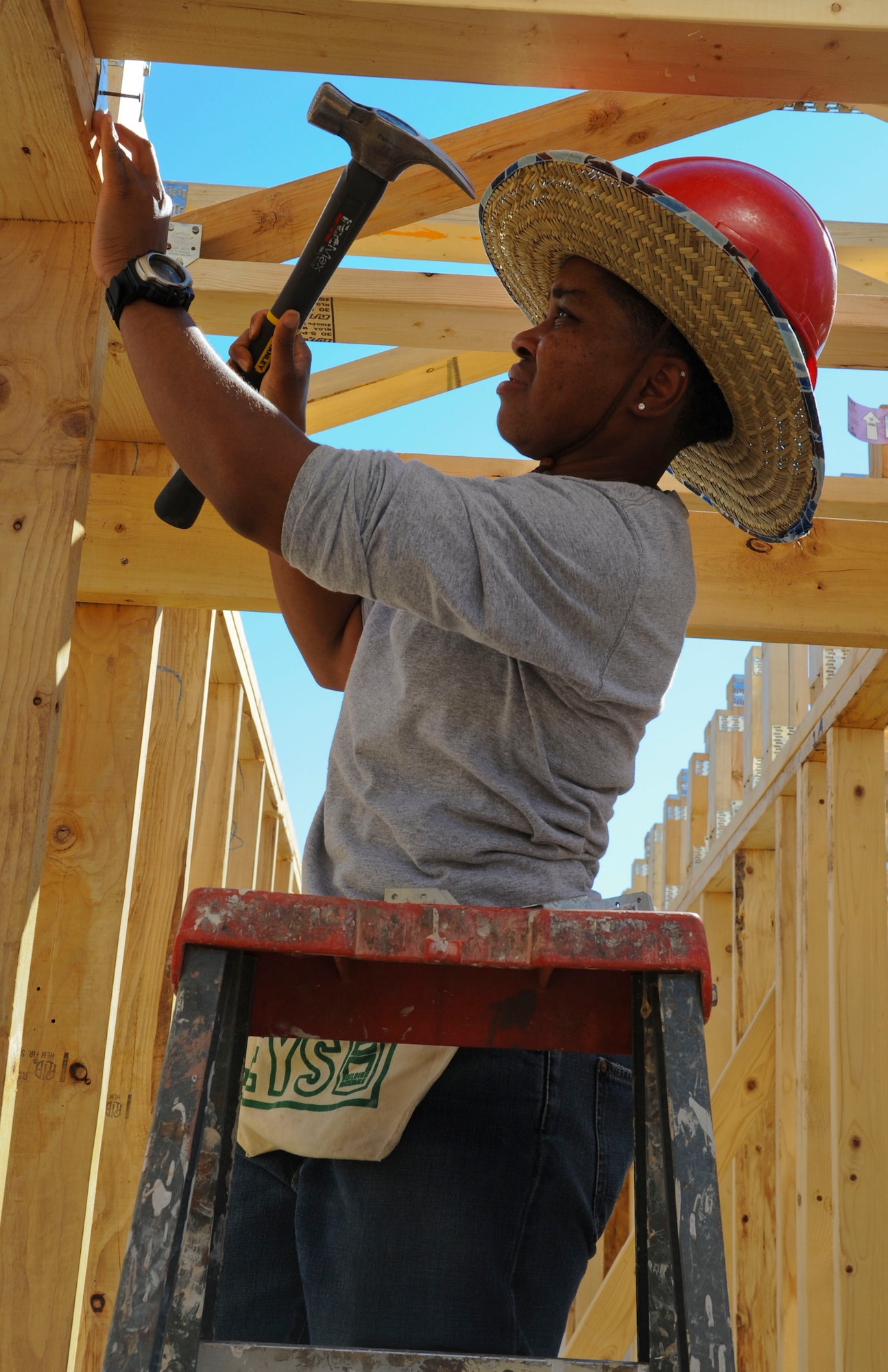 Staff Sgt. Saundra Collins, 607th ACS instructor weapons director, works on building the frame of a home being sponsored by Habitat for Humanity. The 607th ACS dedicates a day of volunteering with Habitat for Humanity every few months.   (U.S. Air Force photo by Staff Sgt. Darlene Seltmann)